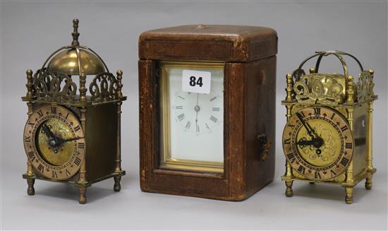 A cased carriage clock and two small lantern clocks